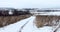 Winter panoramic landscape with road and field