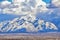 Winter Panoramic view of Snow capped Wasatch Front Rocky Mountains, Great Salt Lake Valley and Cloudscape from the Bacchus Highway