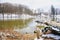 Winter in park with old trees and lake