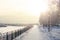 Winter park, snow-covered path, lanterns and a fence