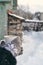 Winter picture: hands in knitted gray gloves holding a Cup of hot coffee on a snowy day on a wooden rustic background in the