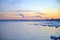 Winter Pink sunset and Urban Landscape view on a Baltic Sea Side. Sunset with snowy boulders and beach landscape. Baltic sea,