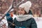 Winter portrait of a charming young woman with freckles on her face. Cute girl looking at the camera on a background of