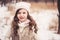 Winter portrait of cute smiling child girl on the walk in snowy forest