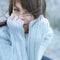 Winter portrait of a girl in sweater. Close up woman freezing outdoor portrait