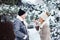 winter portrait of happy couple playing, blowing snow and spending good day outdoor