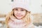 Winter portrait of smile child girl in hat and scarf