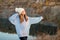 Winter portrait of smilling woman in white hat with big bubo makes funny face