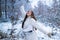 Winter portrait of young beautiful brunette woman in snow Garden. Winter concept. Winter woman fan.