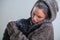 Winter portrait of young kind woman holding big black cat