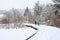 Winter recreation, raised boardwalk trail covered in fresh snowfall and footprints, two people walking