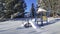 Winter recreation zone for children. Snowy weather. Slide - Kids play area equipment covered with snow with trees on background