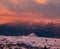 Winter red sunset alpine top view from mountain village. Picturesque seasonal, nature and countryside beauty concept scene