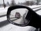 Winter reflection in the rearview mirror car