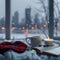 Winter relaxation coffee, candle, book set against city skyline