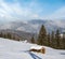 Winter remote alpine mountain village outskirts, countryside hills, groves and farmlands