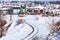 Winter road, houses with snow roofs panorama in bulgarian ski resort Bansko