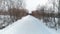 Winter road in the snow, aerial footage. Camera move ahead slowly.