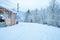 Winter road after the snowfall along wooden construction