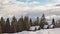 Winter with running clouds over the Carpathian mountains covered with forests and snowdrifts