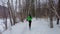 Winter running. Woman runner trail running cold winter forest landscape. Mixed race Asian Caucasian female cross country