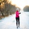 Winter running - Young woman running outdoors