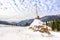 Winter rural landscape, haystacks on the background of snow-capped mountains and forestÐ±, Transcarpathia, Ukraine