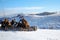 Winter rural scene with snow covered haystacks