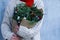 Winter rustic bouquet with fir branches. Female hands holding a Christmas bouquet. New year
