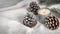 Winter\\\'s Elegance: Frost-Covered Pine Cones and Candlelight