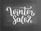 Winter sale lettering on blackboard. Winter sale text lettering for invitation and greeting card, prints and posters. Hand drawn t