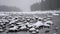 Winter scene on mountain river during heavy snowfall.