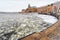 Winter scene with old vintage ships at an icy quay