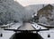 Winter scene on the rochdale canal in hebden bridge with snow covered towpath and houses