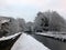 Winter scene on the rochdale canal in hebden bridge with snow covered towpath and houses