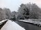 Winter scene on the rochdale canal in hebden bridge with snow covered towpath and houses