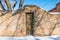 Winter scene of rustic snow-covered adobe wall in Santa Fe, New Mexico