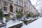 Winter scene with snow covered cars parked along streets in Brooklyn, NY. Brownstones in winter season