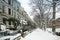 Winter scene with snow covered cars parked along streets in Brooklyn, NY. Brownstones in winter season