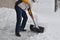 Winter scene - a tall Caucasian man shovels a driveway in a residential area in Ontario Canada