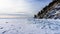 Winter sea day. Chunks of blue ice. Panoramic view of the snow-covered shore of the frozen sea, the lake on a winter, spring day.