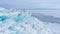 Winter sea day. Chunks of blue ice. Panoramic view of the snow-covered shore of the frozen sea, the lake on a winter, spring day.