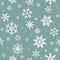 Winter seamless pattern with flat white snowflakes on powder blue background.