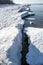 Winter seaside landscape, melting ice and snow on the beach