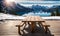 Winter serenity: Empty wooden table with snowy mountain backdrop