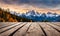 Winter serenity: Empty wooden table with snowy mountain backdrop