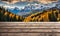 Winter serenity: Empty wooden table with snowy mountain backdrop