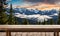 Winter serenity: Empty wooden table with snowy mountain backdrop