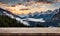 Winter serenity: Empty wooden table with snowy mountain backdrop