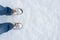 Winter shoes footprint in fresh snow, blue jeans trousers, copyspace